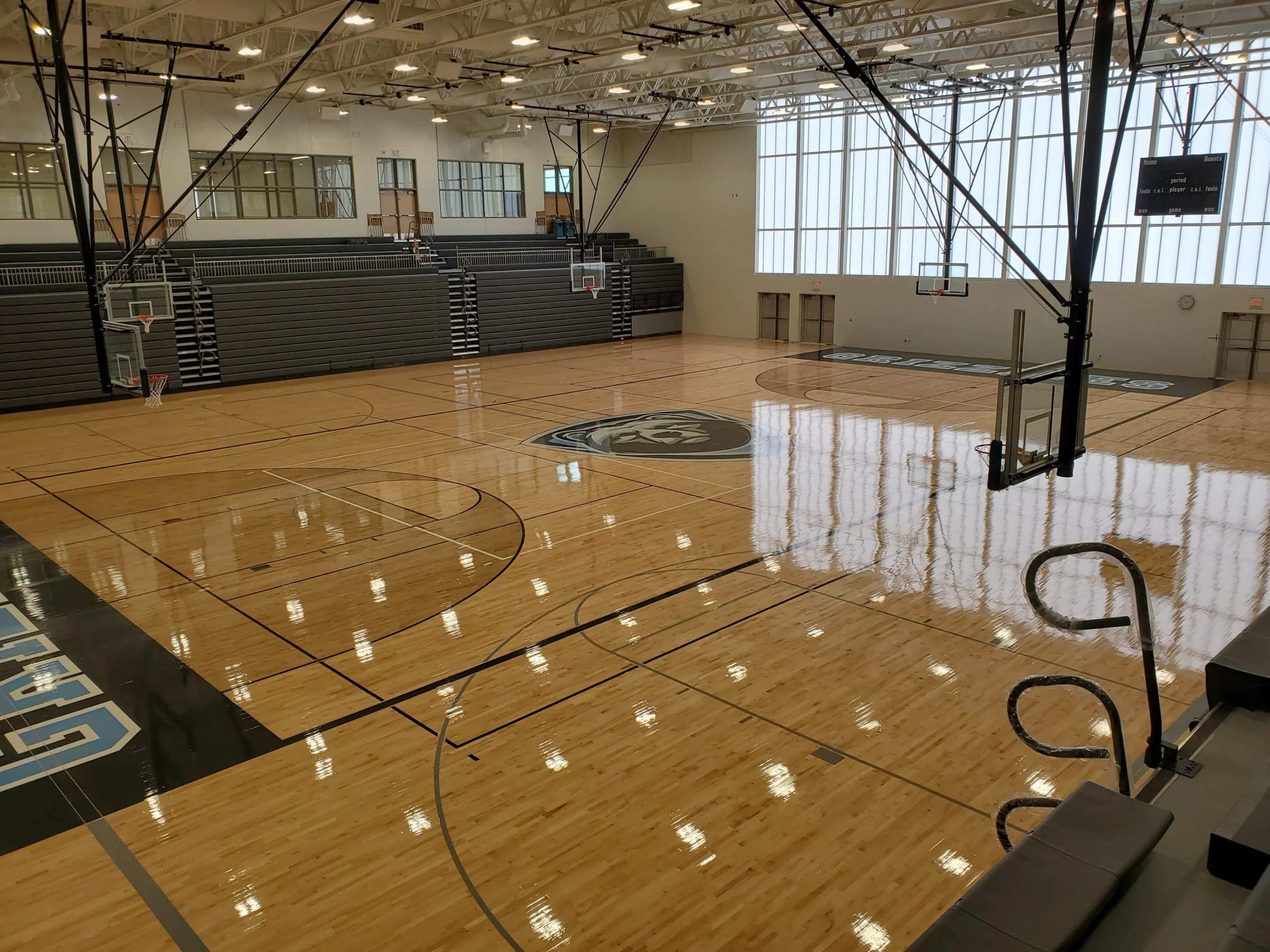 A basketball court with lights on the ceiling.