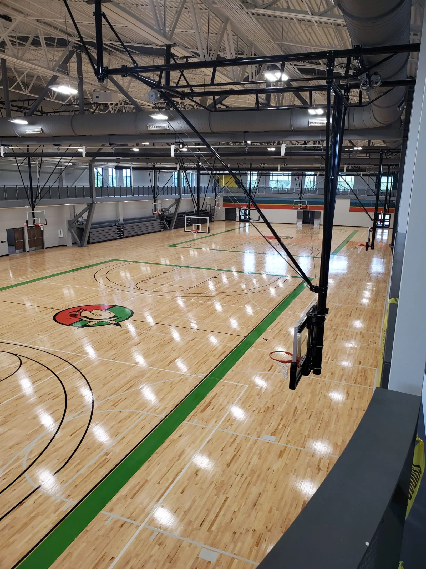 A basketball court with a green line on the floor.