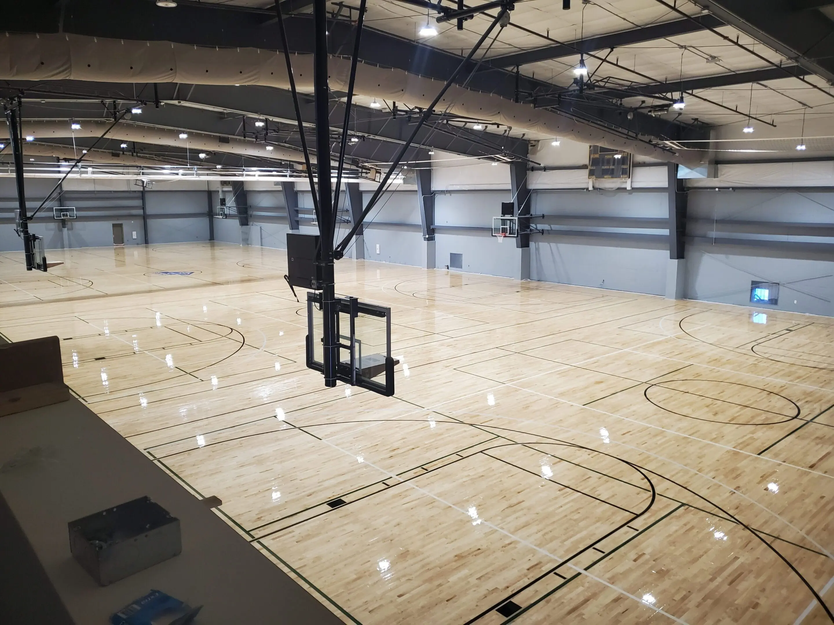 A basketball court with lights on the ceiling.