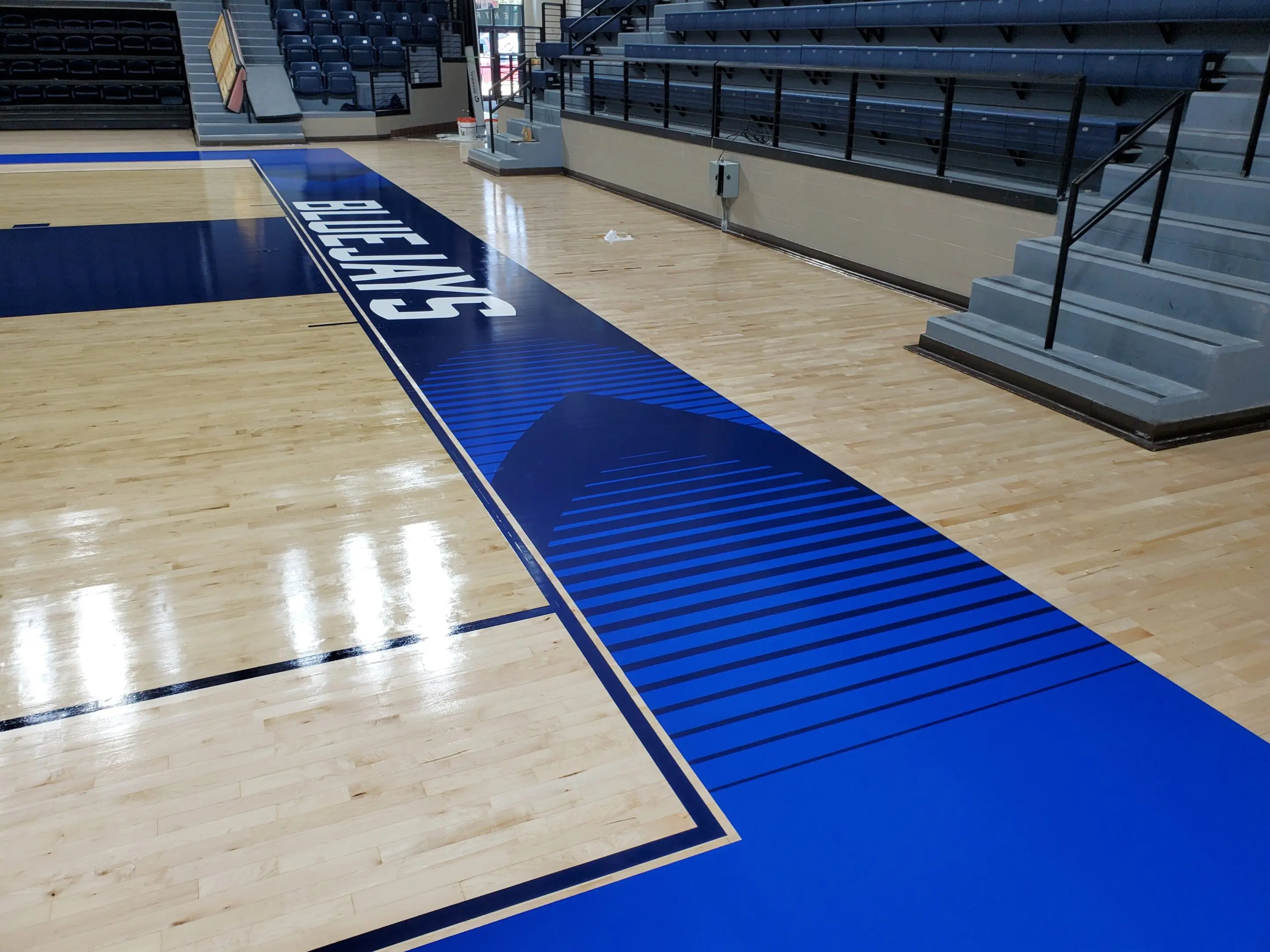 A basketball court with blue and white lines.