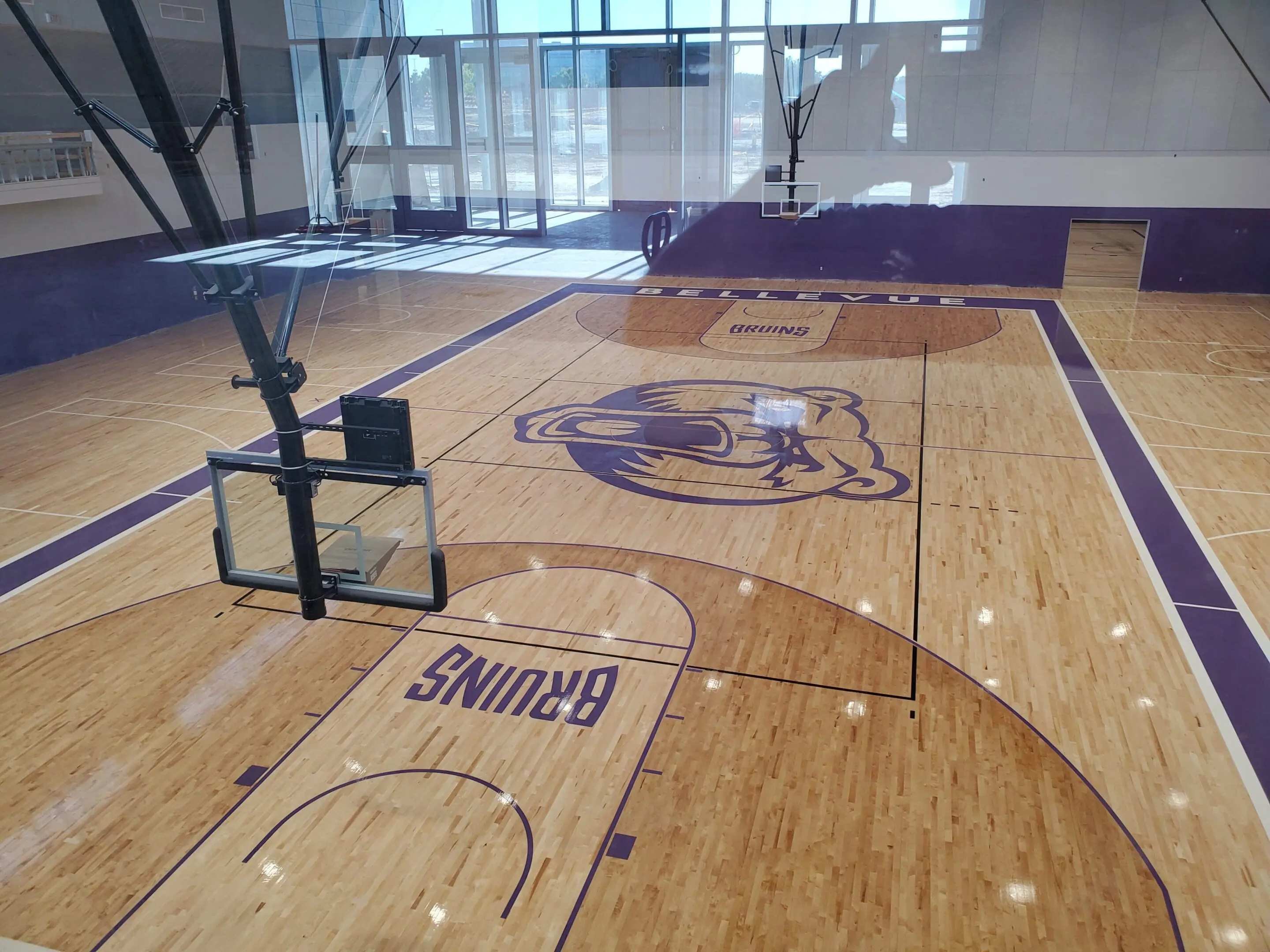 A basketball court with a basket ball hoop and a net.