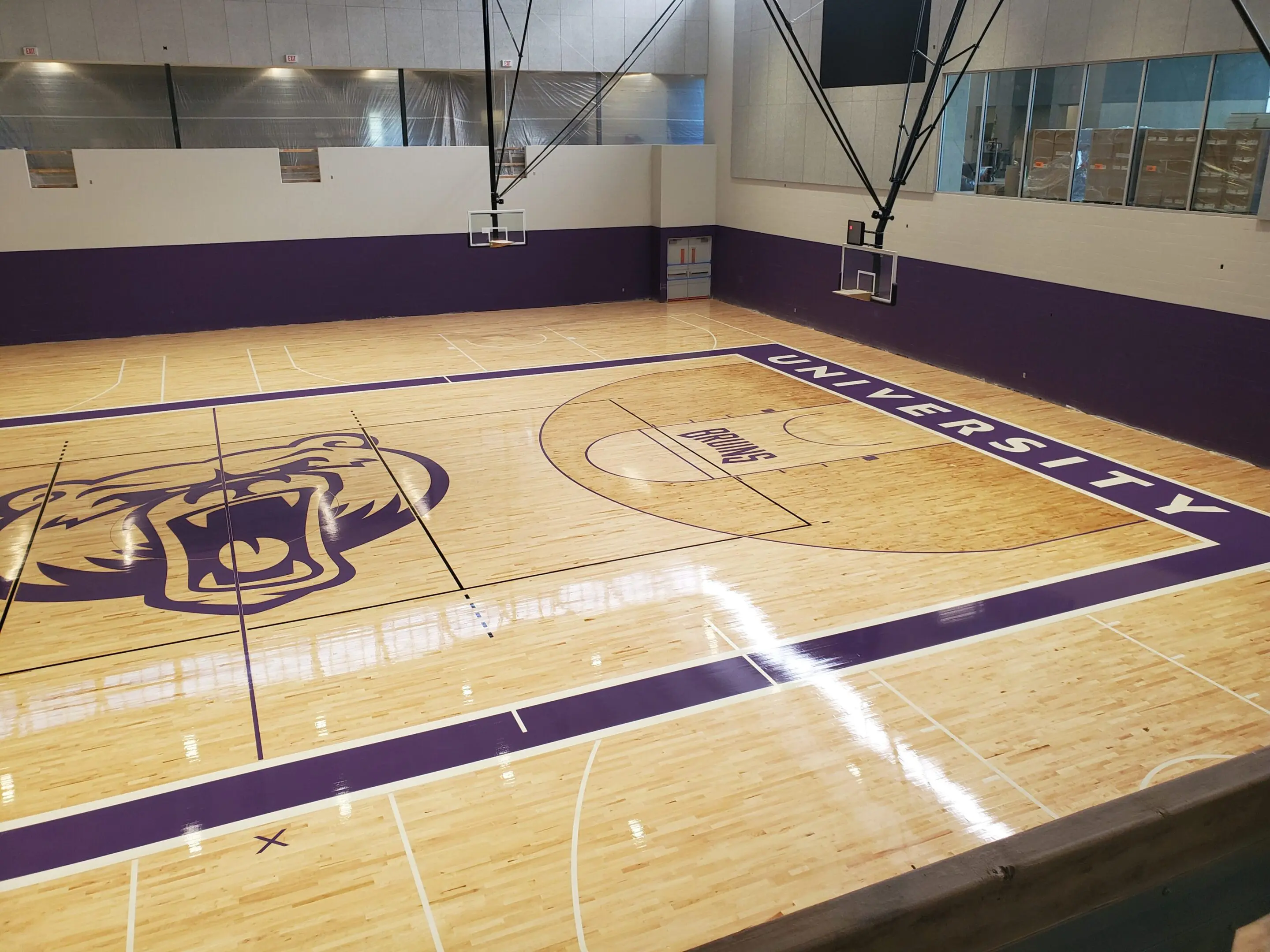 A basketball court with purple and white markings.